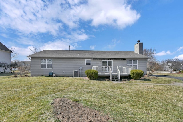 rear view of house featuring a wooden deck, a lawn, central AC unit, and a chimney