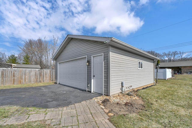 detached garage featuring fence