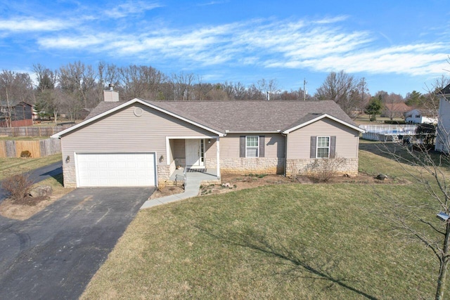 ranch-style home with driveway, stone siding, fence, a front yard, and an attached garage