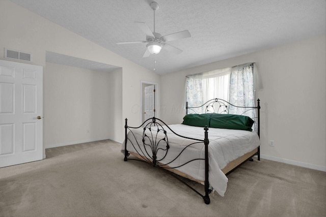 bedroom featuring visible vents, a textured ceiling, baseboards, carpet flooring, and lofted ceiling