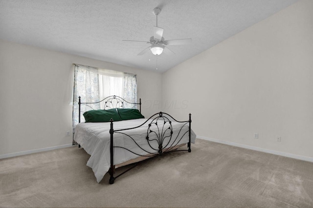 bedroom featuring light colored carpet, a textured ceiling, baseboards, and vaulted ceiling