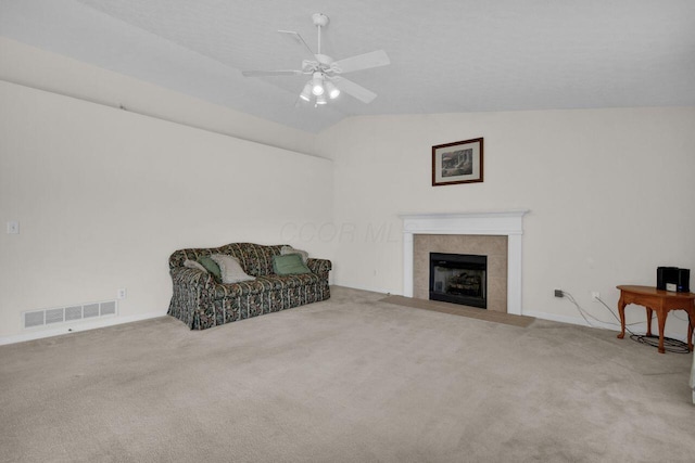 sitting room with vaulted ceiling, carpet, visible vents, and ceiling fan