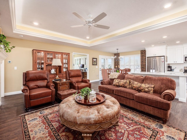 living area featuring recessed lighting, baseboards, a raised ceiling, and dark wood-style flooring