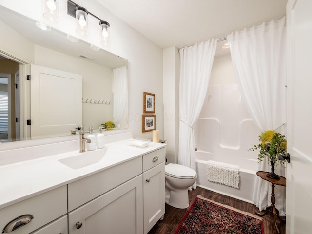 full bathroom featuring visible vents, toilet, wood finished floors, vanity, and shower / bathtub combination with curtain