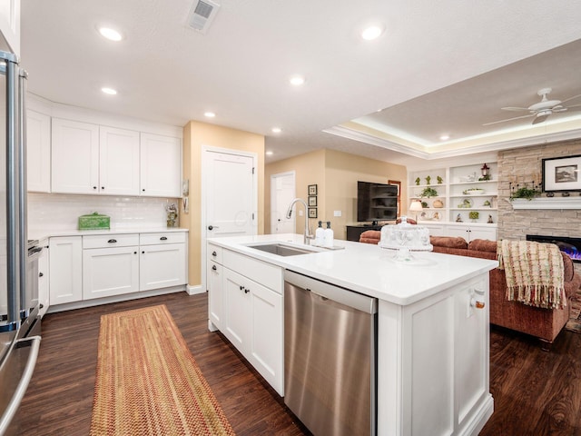 kitchen with a sink, visible vents, stainless steel dishwasher, and open floor plan