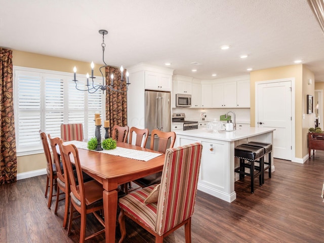 dining room with recessed lighting, baseboards, and dark wood-style floors