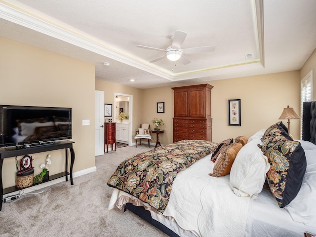 bedroom with a ceiling fan, a raised ceiling, light colored carpet, and baseboards