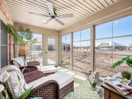 sunroom with a ceiling fan and a wealth of natural light