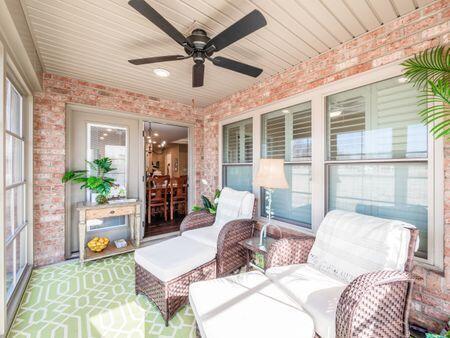 sunroom / solarium featuring ceiling fan