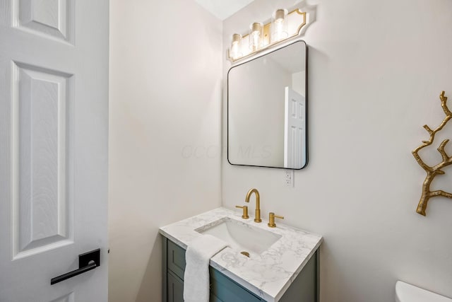 bathroom featuring toilet and vanity