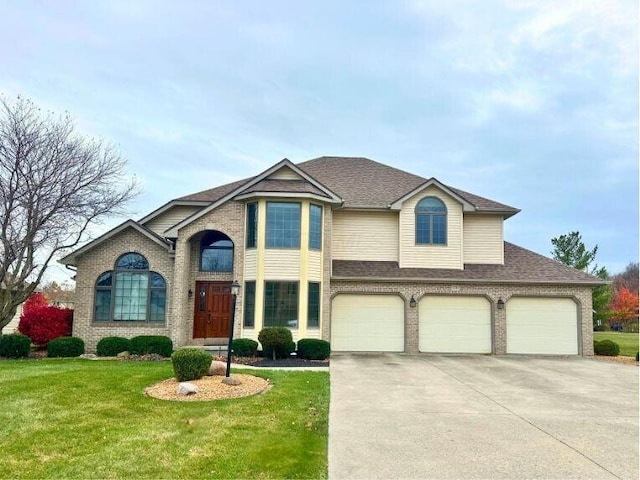 view of front of home with a garage, a front yard, concrete driveway, and brick siding