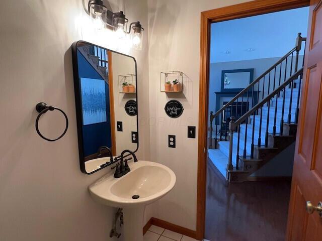 bathroom with tile patterned flooring and baseboards