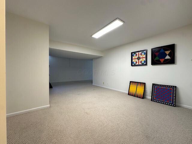 finished below grade area featuring carpet flooring and baseboards