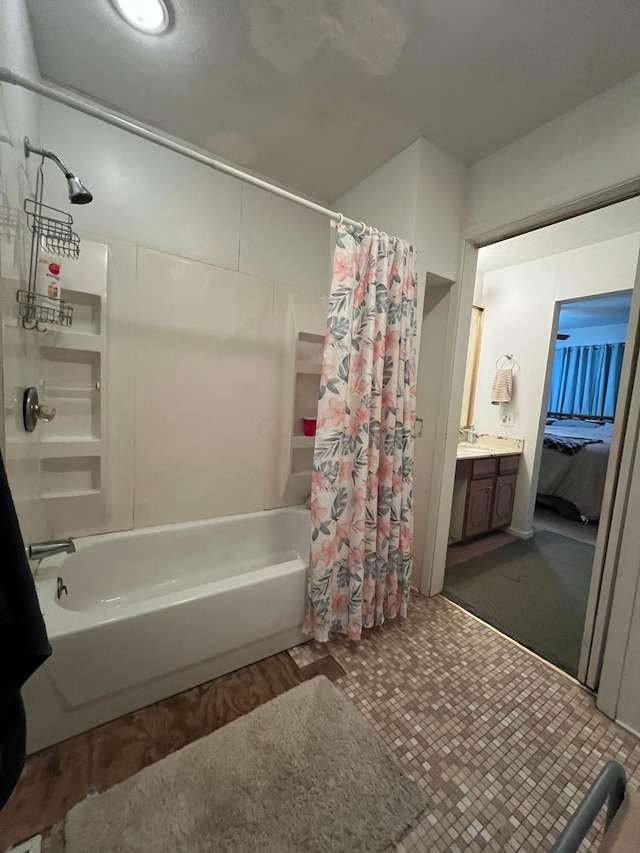 bathroom with connected bathroom, vanity, and shower / tub combo with curtain