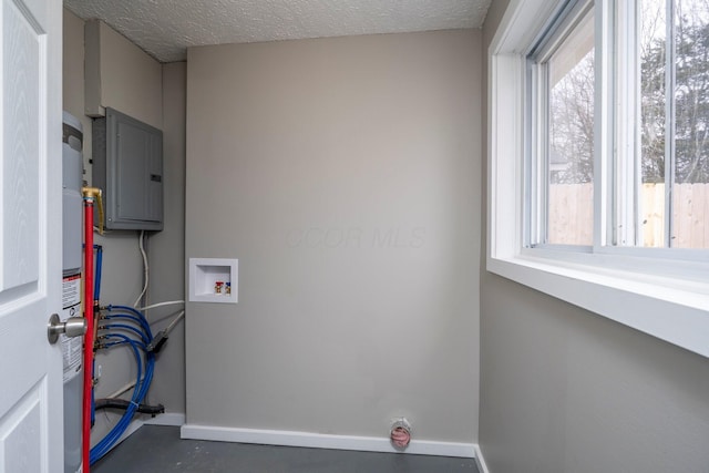 laundry room featuring hookup for a washing machine, baseboards, laundry area, and a textured ceiling