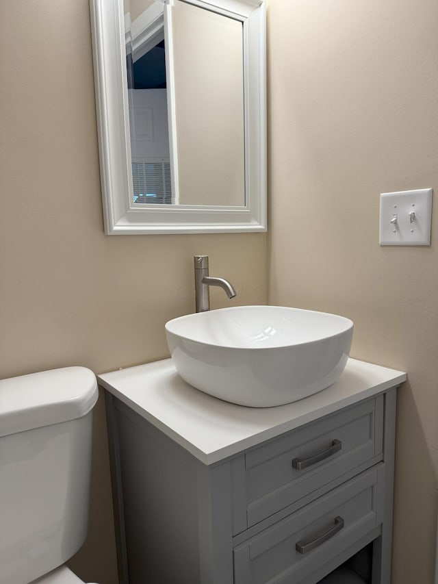 bathroom with toilet and vanity