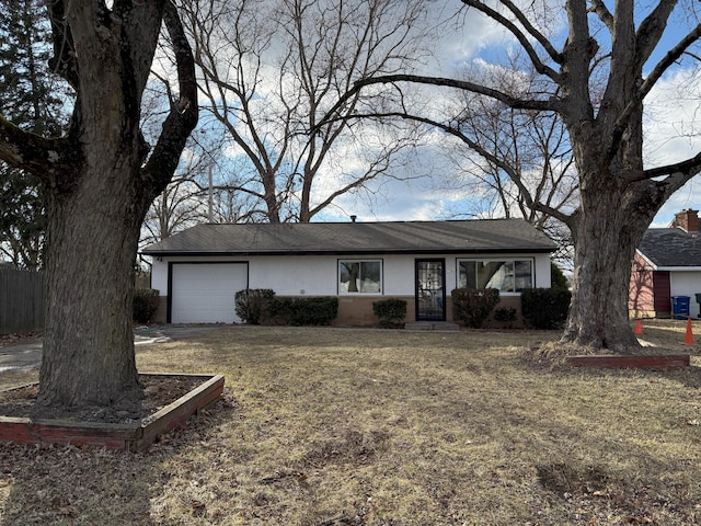 ranch-style home with a front yard, brick siding, an attached garage, and stucco siding