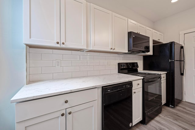 kitchen with decorative backsplash, white cabinets, and black appliances