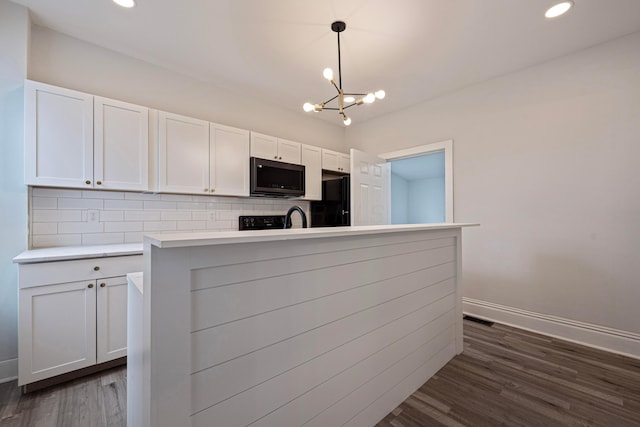 kitchen featuring tasteful backsplash, visible vents, white cabinetry, and freestanding refrigerator