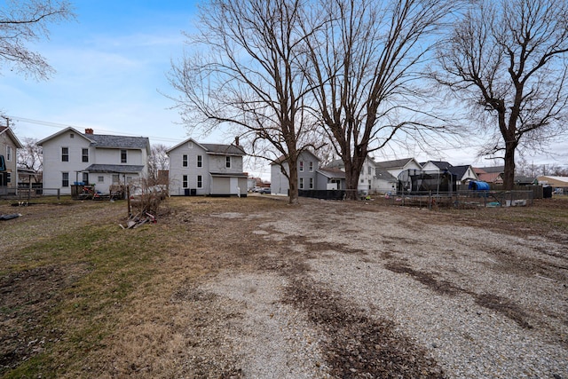 view of yard featuring fence and a residential view