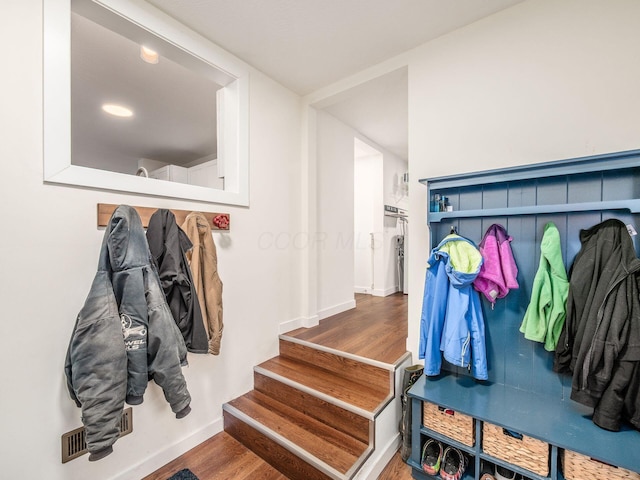 mudroom featuring wood finished floors and baseboards