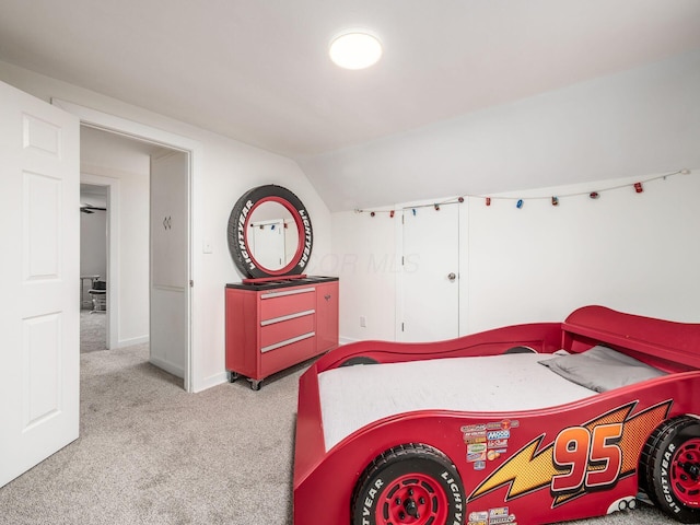 bedroom with lofted ceiling, baseboards, and carpet flooring