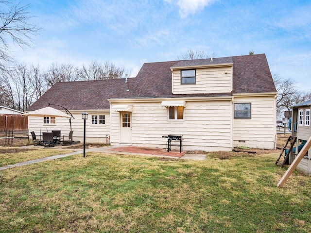 back of property with a shingled roof, fence, a yard, crawl space, and a patio area