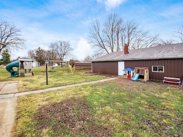 view of yard featuring a playground and an outdoor structure