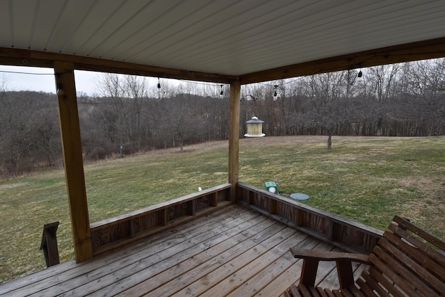 deck featuring a yard and a view of trees