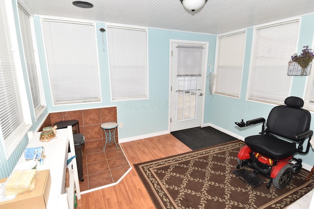 interior space with baseboards and wood finished floors