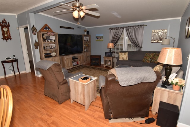 living room with ornamental molding, light wood-style floors, and ceiling fan