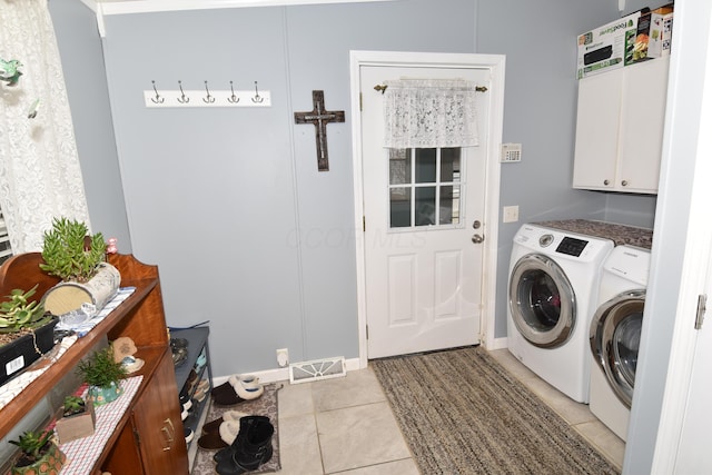 clothes washing area featuring cabinet space, light tile patterned floors, visible vents, and independent washer and dryer