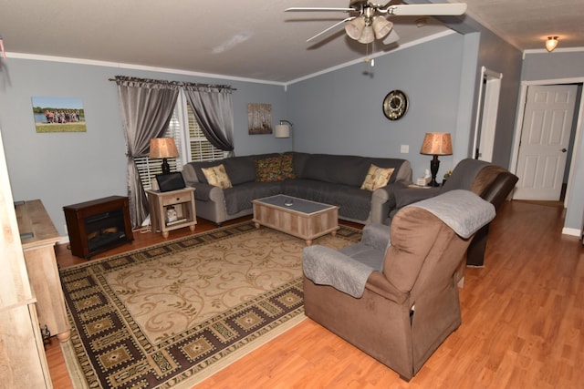 living area with a ceiling fan, crown molding, and wood finished floors