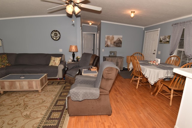 living room with light wood-style floors, ceiling fan, and crown molding