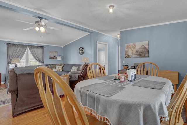 dining area with a ceiling fan, wood finished floors, and crown molding