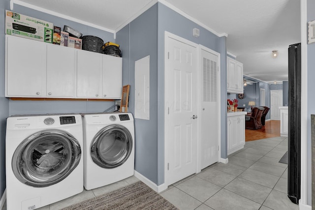 clothes washing area featuring light tile patterned floors, cabinet space, separate washer and dryer, and crown molding