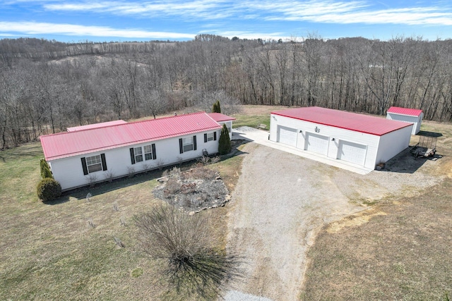 drone / aerial view with a wooded view