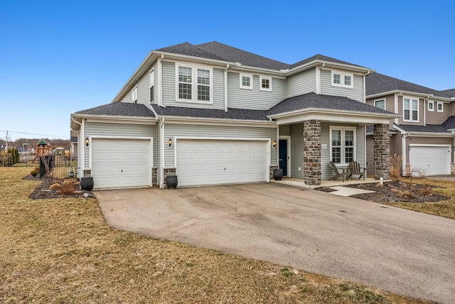 view of front of house with an attached garage, fence, driveway, and roof with shingles