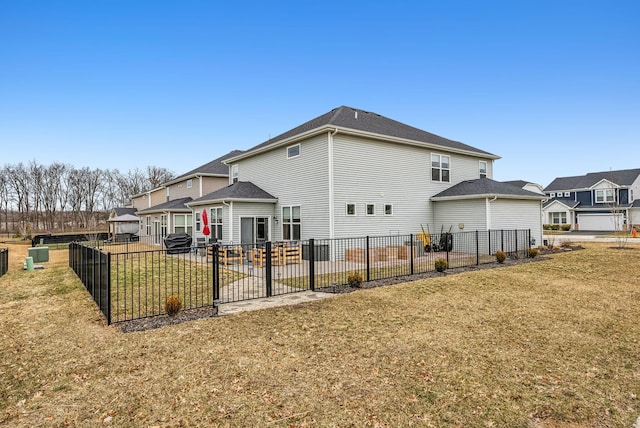 back of property with a patio area, a residential view, a yard, and fence