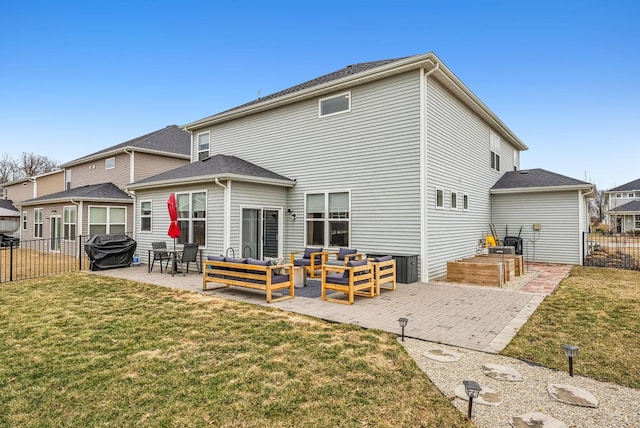 back of house featuring a yard, outdoor lounge area, a patio, and fence