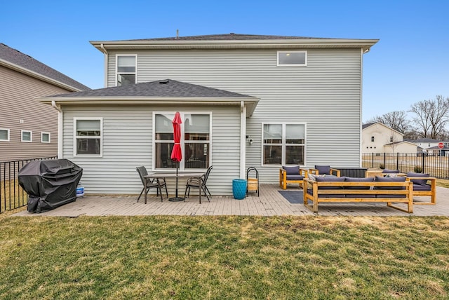 back of house featuring an outdoor living space, a yard, a patio, and fence