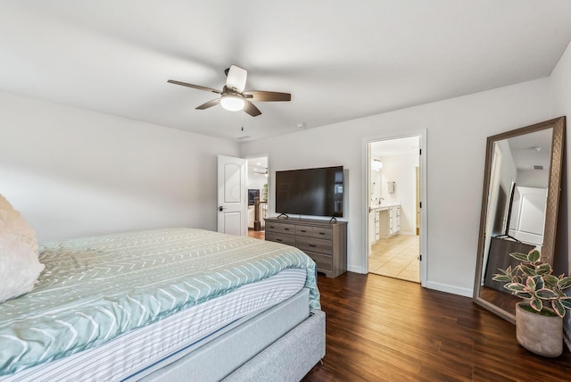 bedroom with ceiling fan, wood finished floors, baseboards, and connected bathroom