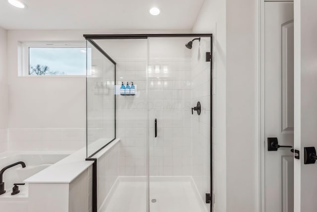 bathroom featuring recessed lighting, a garden tub, and a stall shower