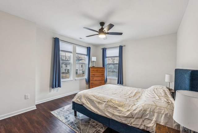 bedroom with visible vents, ceiling fan, baseboards, and wood finished floors