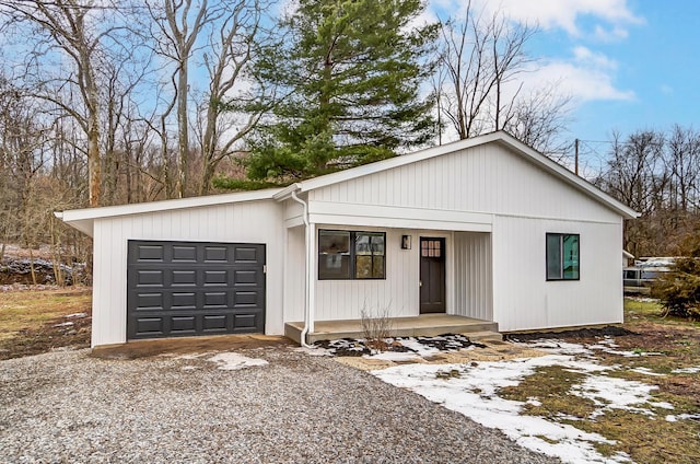 view of front facade with a porch, driveway, and a garage