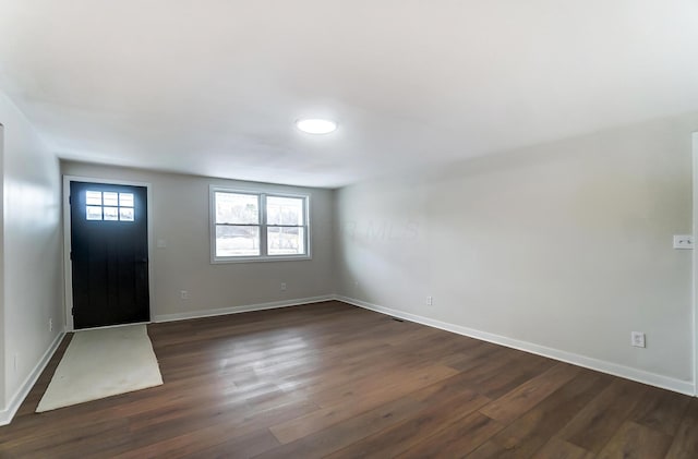 entryway with dark wood-type flooring and baseboards