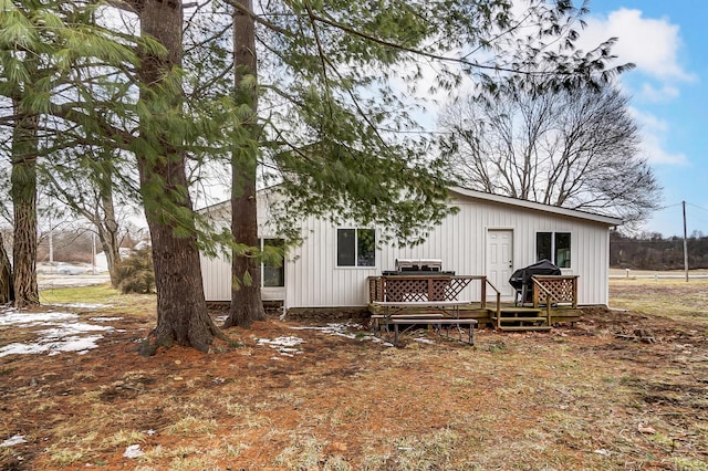 back of property featuring a wooden deck