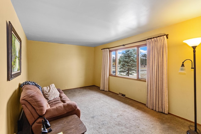 carpeted living area featuring visible vents