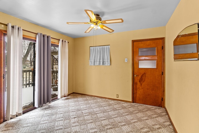 interior space with carpet, baseboards, arched walkways, and a ceiling fan