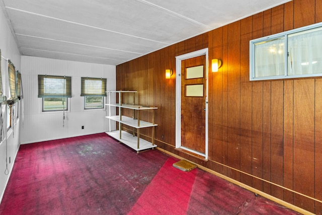 empty room featuring wood walls